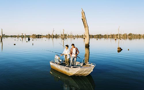 Husband & wife fishing from a boat on Lake Mulwala