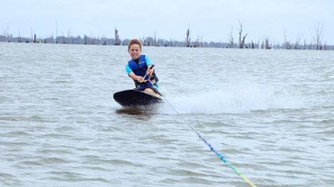 Young boy wake boarding on Lake Mulwala